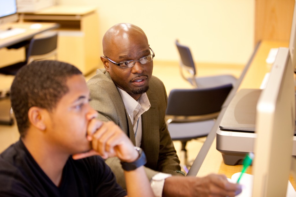 JSU graphic arts professor Jimmy Mumford (right) works with a student in the Mac lab.