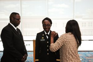 Graduate Jerrica Culpepper (center) is pinned by parents Jerry and Martha Culpepper during the joint Air Force and Army commissioning ceremony following JSU's spring 2013 commencement. Culpepper is now a second lieutenant in the United States Army.