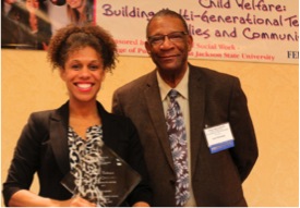 Dr. Leon Chestang, Associate Dean School of Social Work, presents a plaque to Sarah Culbertson