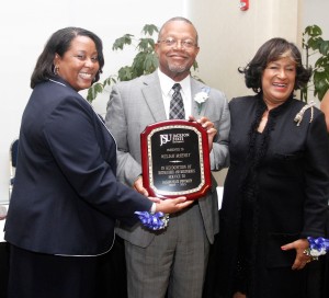 Human Resources Executive Director Robin Pack and JSU President Carolyn W. Meyers give Dr. William McHenry a retirement plaque during a special dinner on May 1, 2014.
