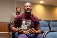 Meco Shoulders, a senior entrepreneur major from Jackson, received a book from one of the panelists.