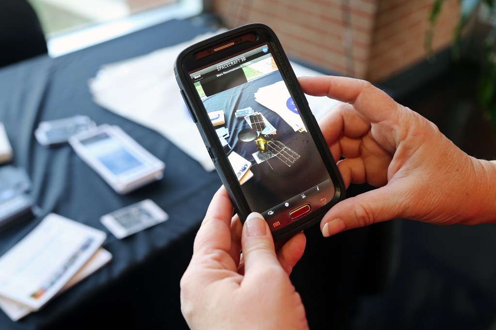 A space station appears to hover over the registration desk at JSU's NASA Days, via a free smartphone app. (Photo by Charles A. Smith)