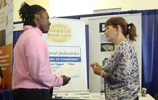 Crest Industries Director of Recruiting and Public Relations Kris Hickman speaks with Darius Harris, a senior in computer science, at Jackson State University’s Career Fair held at the Walter Payton Recreation Complex on Thursday, Oct. 2, 2014. (Photo by Charles A. Smith, JSU)