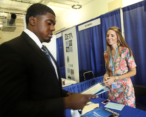 Emily Lambuth, Emily Lambuth, human resources office manager for the Walmart Distribution Center in Brookhaven, speaks with Tevin Chapman, a senior accounting major, at Jackson State University’s Career Fair held at the Walter Payton Recreation Complex on Thursday, Oct. 2, 2014. (Photo by Charles A. Smith, JSU)