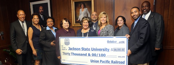 Jackson State University President Dr. Carolyn W. Meyers, center, receives a large check from Union Pacific Railroad to provide scholarships and meet other needs at JSU. Pictured, from left: Dr. James C. Renick, provost and senior vice president for academic and student affairs; Career Management and Placement Center Director Lori Swanier; College of Business Associate Dean Dr. Sheila Porterfield; Interim Vice President for Institutional Advancement Dr. Mary M. White; President Meyers; College of Business Dean Dr. Ramin Maysami; and Union Pacific officials: Kate Betsworth, Linellis Santiago, Lovell Cox and Aaron Evans. (Photo by Charles A. Smith, JSU)