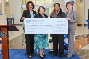 Blue Cross & Blue Shield of Mississippi Foundation Executive Director Sheila Grogan (right) presents a check for $129,225 to Dr. Mary M. White, Jackson State University interim vice president for institutional advancement (second from left), and Dana A. Brown, associate vice president for business and finance (left), and Velesha Williams, director of the Metro Jackson Community Prevention Coalition, on Wednesday, Nov. 19, 2014. The money is for the “One Fit JSU” Wellness Initiative to boost a healthy campus environment that reaches into the Jackson metro area. (Photo by Anissa Hidouk, JSU)