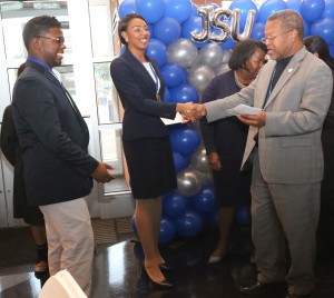 Sierra Jackson and Javis Jones (left) are congratulated by Dr. William McHenry, executive director, Mississippi eCenter @ JSU for winning the JSU Social Entrepreneurship Business Plan Challenge on Nov. 14, 2014. (Photo Anissa Hidouk, JSU)