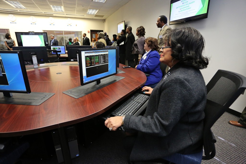 Jackson State University President Dr. Carolyn W. Meyers tries her hand at a state-of-the-art trading floor terminal in the College of Business at its grand opening Nov. 14, 2014. (Photos by Charles A. Smith)