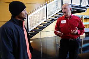 JSU student Raphel Nicks, an electrical engineering major from Forest, and Entergy's Roger Kitchens speak during the job fair Tuesday. (Photo by Charles A. Smith, JSU)
