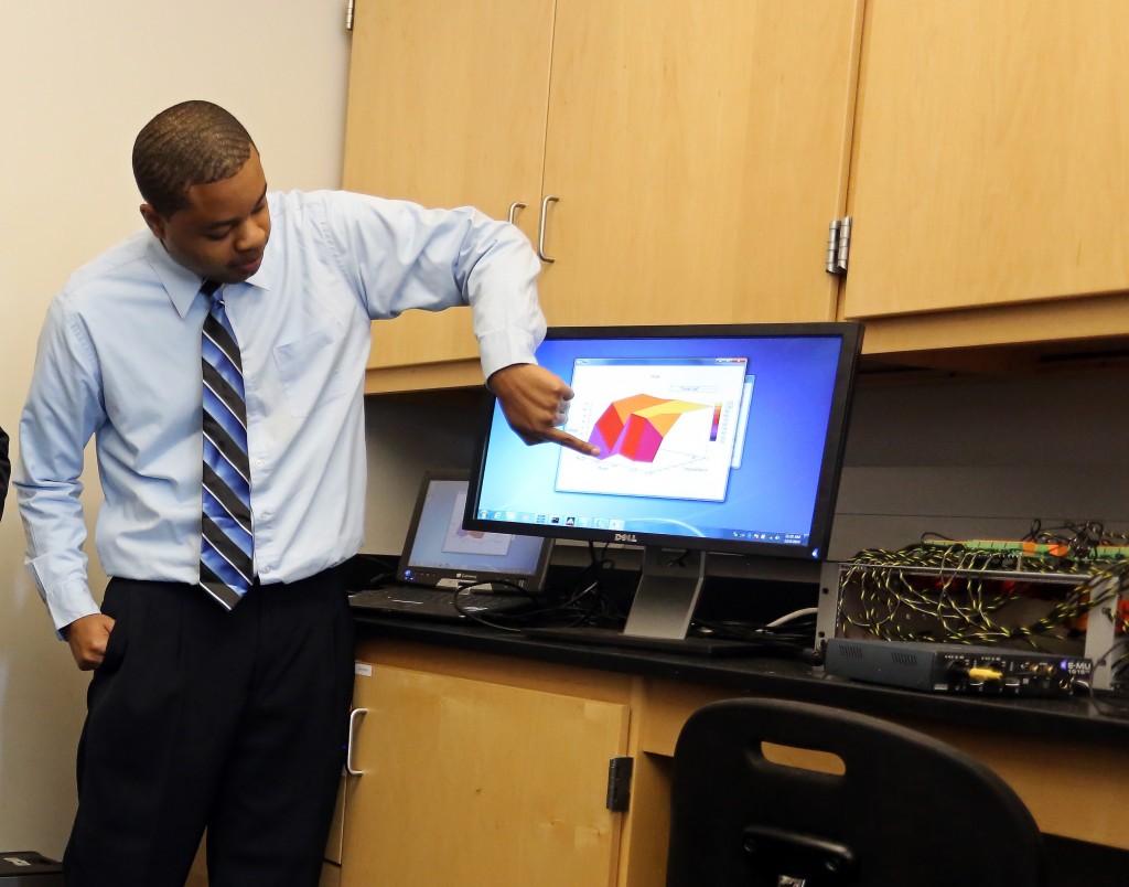 Joshua Turner, a senior engineering student, demonstrates an amplification measuring device. (Photo by Charles A. Smith, JSU)