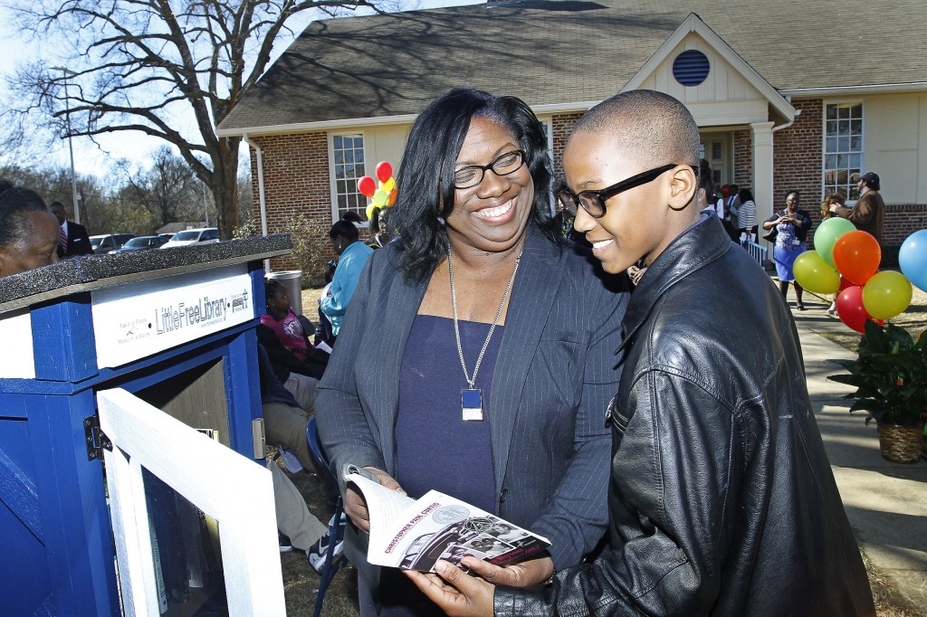 Dr. Kimberly Hilliard, executive director of JSU’s Office of Community Engagement, shows Jaylin Thornton, 11, a Blackburn 6th grader, the Little Free Library at JSU’s e-City Center, Tuesday, Jan. 27, 2015. (Photo by Charles A. Smith, JSU)