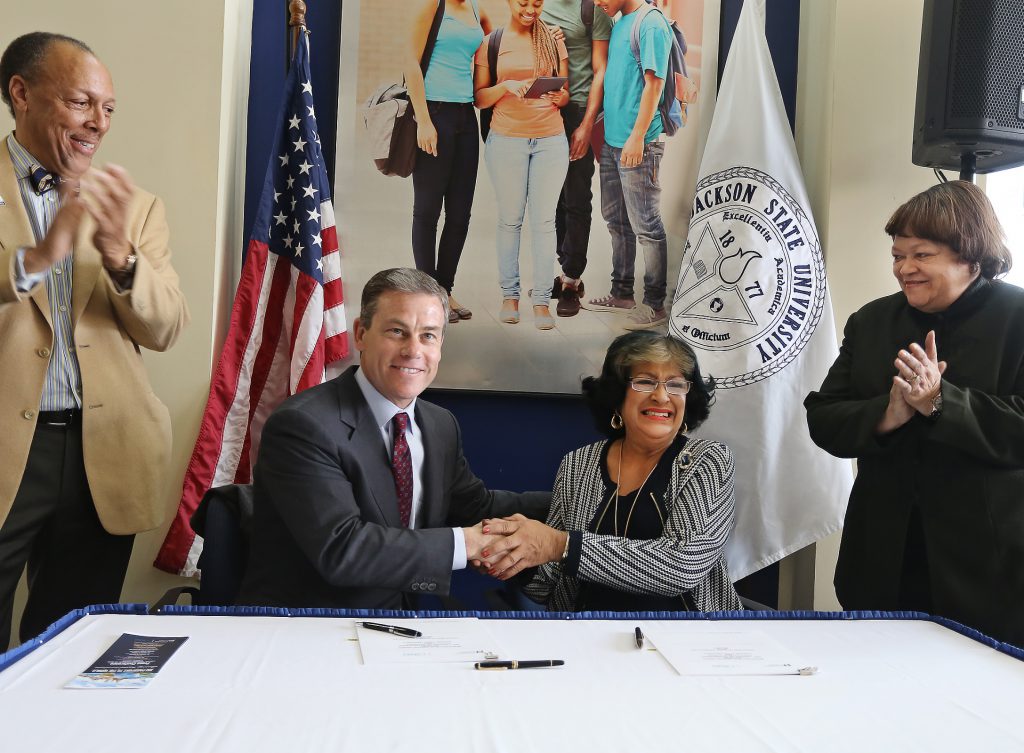Dr. James P. Pellow, president and CEO of the Council on International Education Exchange, (left, seated) and Jackson State University President Carolyn W. Meyers, (right, seated) shake hands after signing an agreement to provide 200 free passports in a model study abroad program at JSU. Looking on are Dr. James C. Renick, provost and senior vice president for Academic and Student Affairs, and Dr. Mary M. White, interim vice president of JSU’s Division of Institutional Advancement. (Photo by Charles A. Smith)