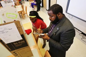 Godwin Ashley Dilibe Offiah, a senior in civil engineering, judges an entry on Peanut Power by Desia Barnes, a Blackburn student. (Photo by Charles A. Smith, JSU)