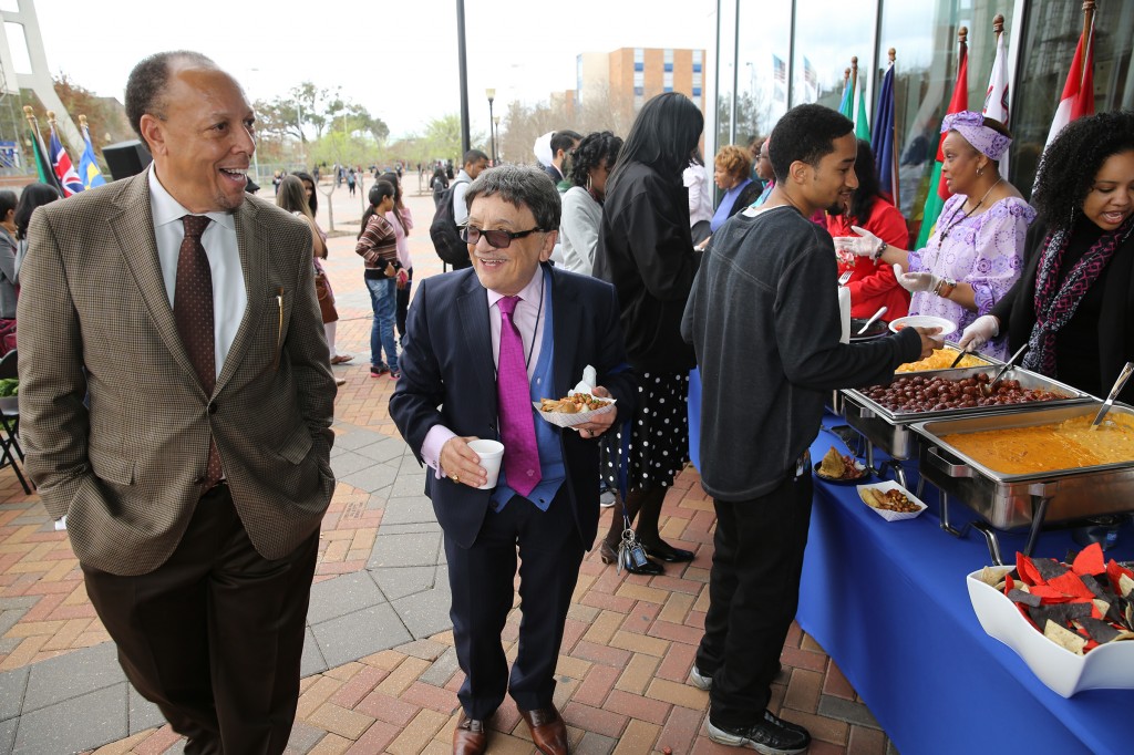 Dr. James C. Renick, provost and senior vice president for Academic and Student Affairs (left), and College of Science, Engineering and Technology Dean Dr. Richard Alo enjoy opening ceremonies for International Week, March 23, 2015. (Photo by Deontae Williams, JSU)