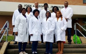 JSU Professor Clement G. Yedjou’s Cancer Research Group studying links between common chemicals and cancer includes, front row (from left to right): Keara Johnson, Imani Nelson, Myeisha Foutain and Alexis Mosley (all senior biology majors); back row (from left to right): Yedjou, Chantill Williams-Smith (master student), Justin McDowell (master candidate), Shalom Dasari (Ph.D. student), Ariane Mbemi (Ph.D. student), and William Johnson (doctorate candidate). The two candidates are graduating in May 2015. (Photo: Jackson State University)
