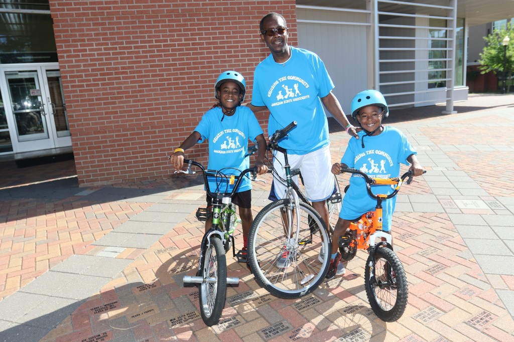 With support from father Will McDowell, two participants ready to burn rubber during JSU's annual Cruising the Community event include sons 11-year-old Wilton and 7-year-old Will. (Photo by Charles A. Smith/JSU)