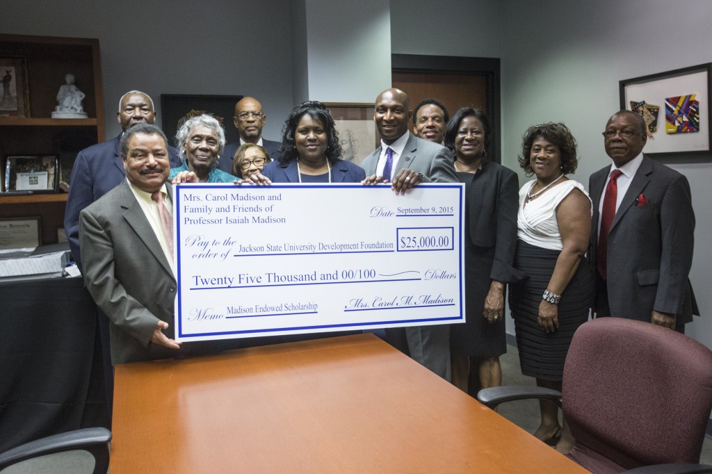 Family members of the late Rev. Dr. Isaiah Madison, a former associate professor of political science, joins JSU faculty members in presenting a $25,000 check to the College of Liberal Arts. Photo by Charles A. Smith/JSU
