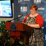 Dierdra Harris-Glover, junior mass communications major, welcomes guests to the launch of the new School of Journalism.