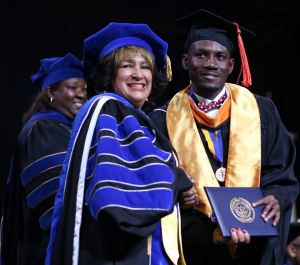 President Carolyn W. Meyers proudly congratulates a graduate for his commitment to excellence. (Photo by Anissa Hidouk/JSU)