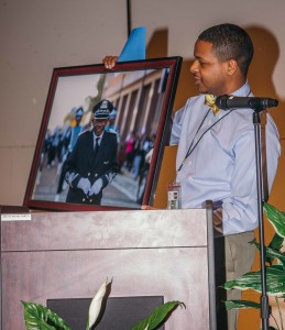 Administrative assistant Ramon L. Jackson presents a photo of Sanford. (Photo by Justin Hardiman/JSU)