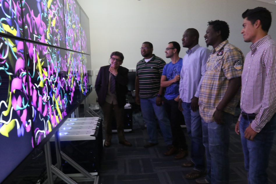 With the program’s doctoral students, Dr. Richard A. Aló, dean of JSU’s College of Science, Engineering and Technology, showcases a Big Data visualization wall of high-resolution images. (Photo by Charles A. Smith/JSU)