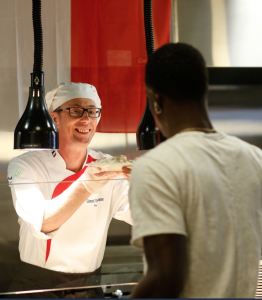 A JSU student prepares to sample a dish by Global Chef Lionel Vandomme from France. (Photo by Charles A. Smith/JSU)