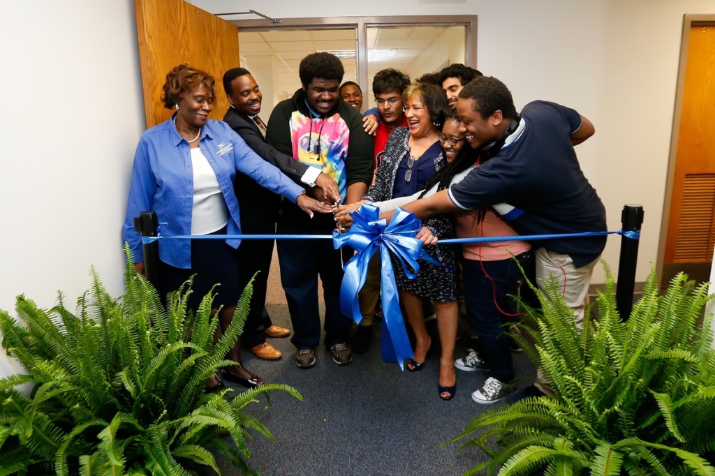 Jackson State University President Carolyn W. Meyers is assisted by students and staff during a ribbon-cutting ceremony Thursday for the new ENGAGE center, for 3-D printing and imaging, in the basement of the H.T. Sampson Library. (Photo by Anissa Hidouk/JSU)