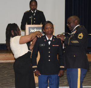 The parents of 2nd Lt. Tamera Cain assists with the pinning ceremony. (Photo courtesy of Brooke Visoski)