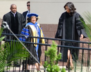 To roaring applause, Meyers escorts Obama to the stage where the first lady will deliver her commencement address. (Photo by Charles A. Smith/JSU)