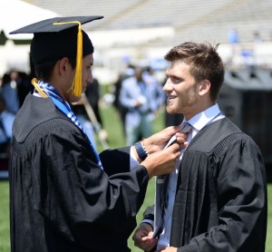 Graduates assist each other before the commencement ceremony begins. (Photo by Darek Ashley/JSU)