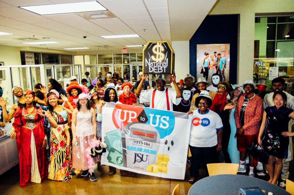 About 70 parade volunteers, many wearing costumes, gather at the Student Center to help rally against the national debt.