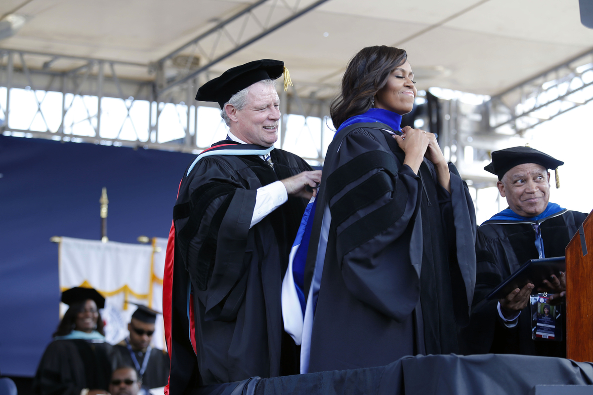 Mississippi Commissioner of Higher Education, Dr. Glenn Boyce, assists Obama after she was conferred an honorary Doctor of Humane Letters by JSU. Photo by Charles A. Smith/JSU)