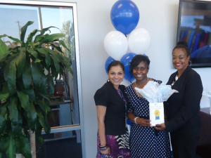 Nicole Gholar-Harris, center, in Title III, earned second place in the contest. She received gas cards totaling $125. She’s congratulated by XXXXXX, xxxxxxxx, and Gwen Caples, director of the JSU Welcome Center.