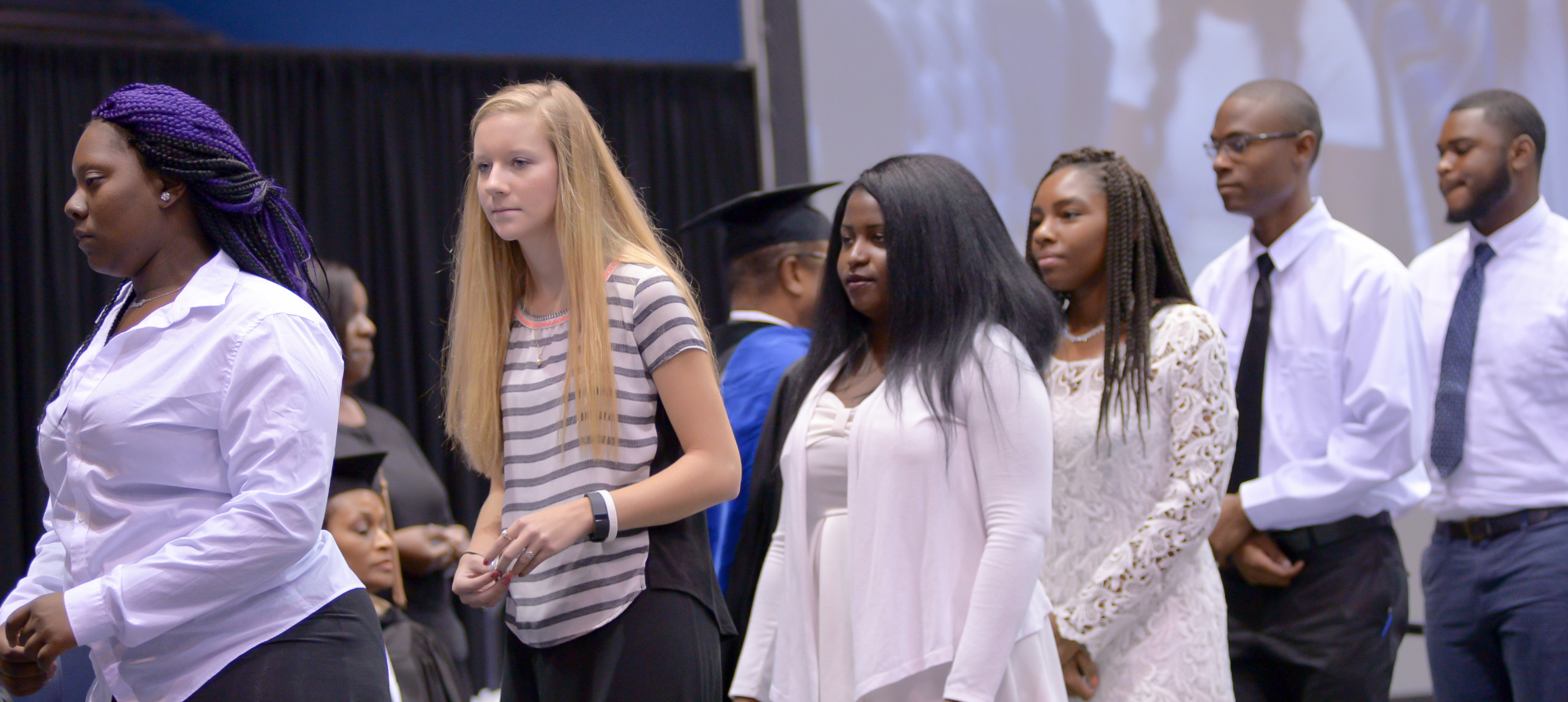 Freshman and transfer students march across the stage to receive a JSU pin and greet administrators, deans and other platform guests. (Photo by Darek Ashley/JSU)