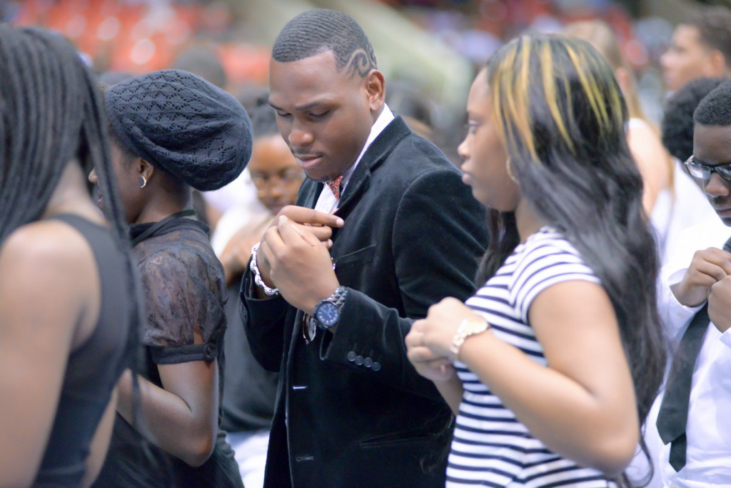 As they prepare for future academic successes, new enrollees place JSU pins on their clothing to symbolize their relationship with JSU. (Photo by Darek Ashley/JSU)