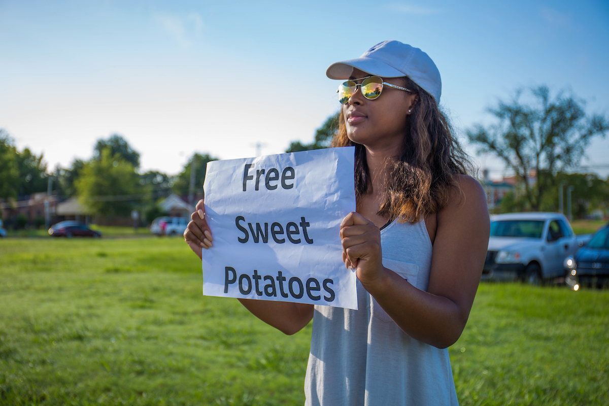 How sweet it is! A JSU student-volunteer directs motorists to its first Crop Drop, a gathering of excess produce donated by farmers and dropped off at a central location. (Photo by Charles A. Smith/JSU)