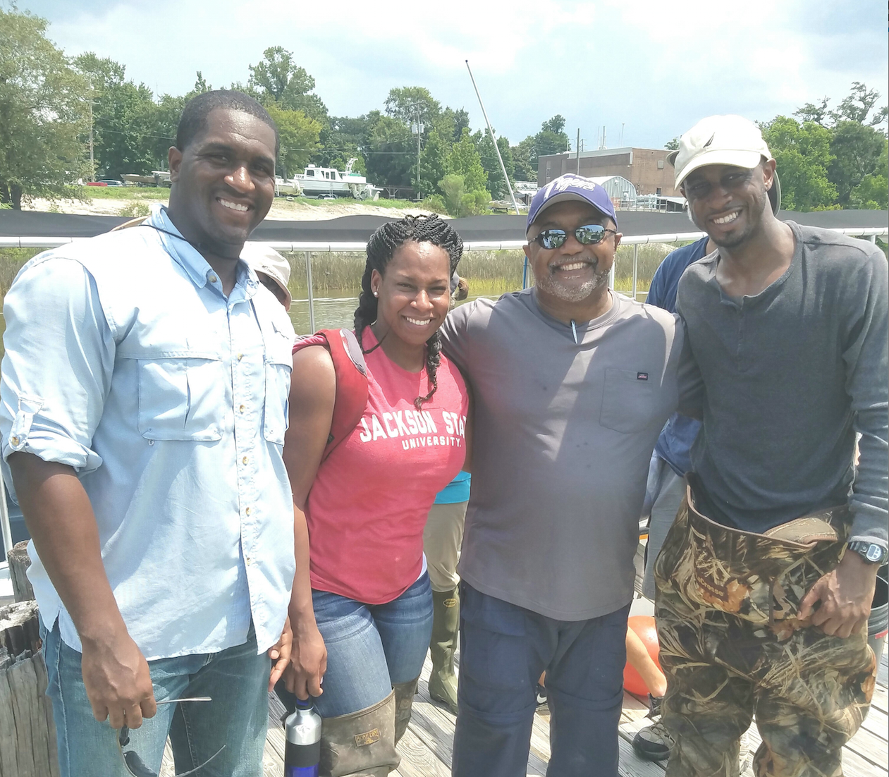 Eric Gulledge, left, Taimei Harris, Dr. Timothy Turner and Willis Lyons at the Gulf Coast Research Laboratory in Ocean Springs, Miss.