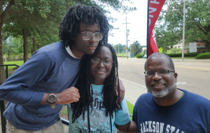 Freshmen, Kambui Bomani. with his parents, has plans of becoming a sports journalist (Photo by Charles A. Smith)