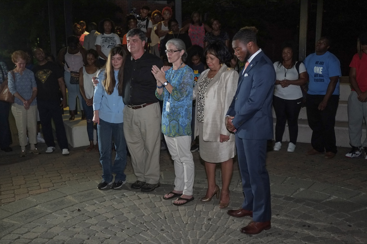 JSU President Carolyn W. Meyers gather to mourn Thursday evening with family members of Benjamin O. Sabine on the Gibbs-Green Memorial Plaza. (Photo by Charles A. Smith/JSU)