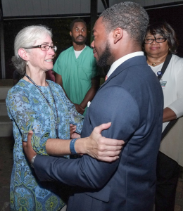 SGA President Kendall Bunch provides solace to Gina Sabine, mother of JSU student Benjamin Sabine. (Photo by Charles A. Smith/JSU)