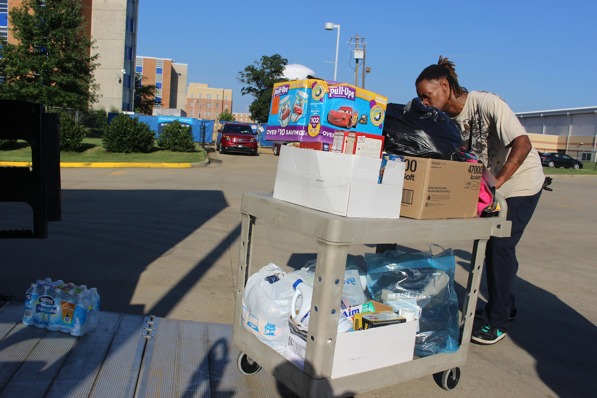 A volunteer pushes a cart of goods for delivery to an impacted area in southwestern Mississippi, where numerous victims were displaced from their homes. (Photo by Kentrice S. Rush/JSU)