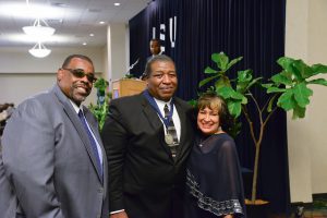 JSU President Carolyn W. Meyers and Athletics Director Wheeler Brown congratulate former football standout Phillip Perkins. (Photo by Darek Ashley/JSU.)