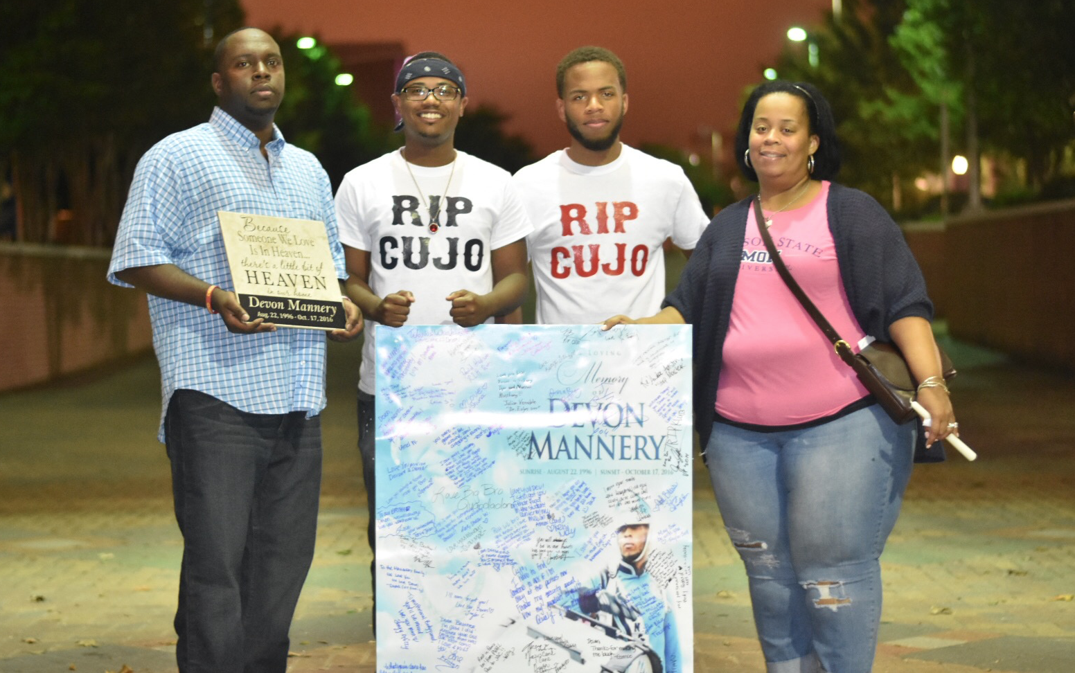 Seventeen-year-old Joshua Mannery, third from left, joins friends and supporters on JSU’s campus who gathered to remember his brother Joshua. The vigil was held Thursday on the Gibbs-Green Memorial Plaza with more than 600 people in attendance. (Photo by William Kelly III/Courtesy of the Blue & White Flash)