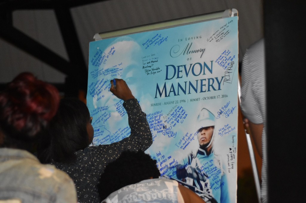 Students take turn writing tributes on a message board in remembrance of Devon. (Photo by William Kelly III/Courtesy of the Blue & White Flash)