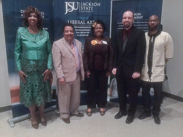 Faculty members in JSU’s College of Liberal Arts celebrate their colleague’s new distinction as Teacher of the Year. Appearing with honoree and associate professor of history Dr. Mark Bernhardt, second from right, are Dr. Bessie House-Soremekun, left, associate dean in the College of Liberal Arts; Dr. Mario Azevedo, dean of the College of Liberal Arts; Dr. Preselfannie Whitfield-McDaniels, associate professor of English; Bernhardt; and Dr. Rico Chapman, interim chair of the Department of History and Philosophy. (Photo by L.A. Warren)