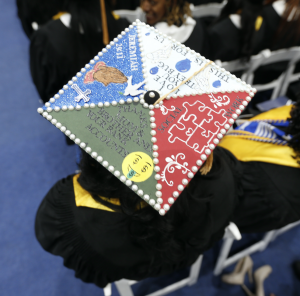 A graduate finds a unique way to thank her family for contributing to her degree. (Photo by Charles A. Smith/JSU)