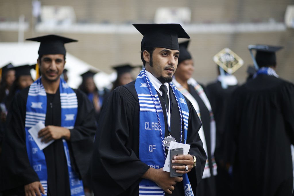 Graduates prepare to walk across the stage to receive their degrees. (Photo by Charles A. Smith/JSU)