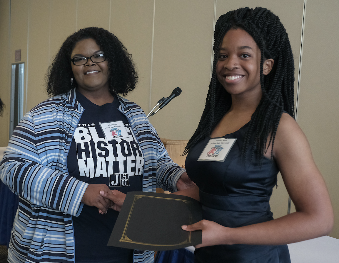 Dr. Helen Crump, associate English professor in the Department of English and Modern Foreign Languages and co-coordinator of the fest presents JSU student Brittany Keys with the Margaret Walker Award (Charles A. Smith/JSU)