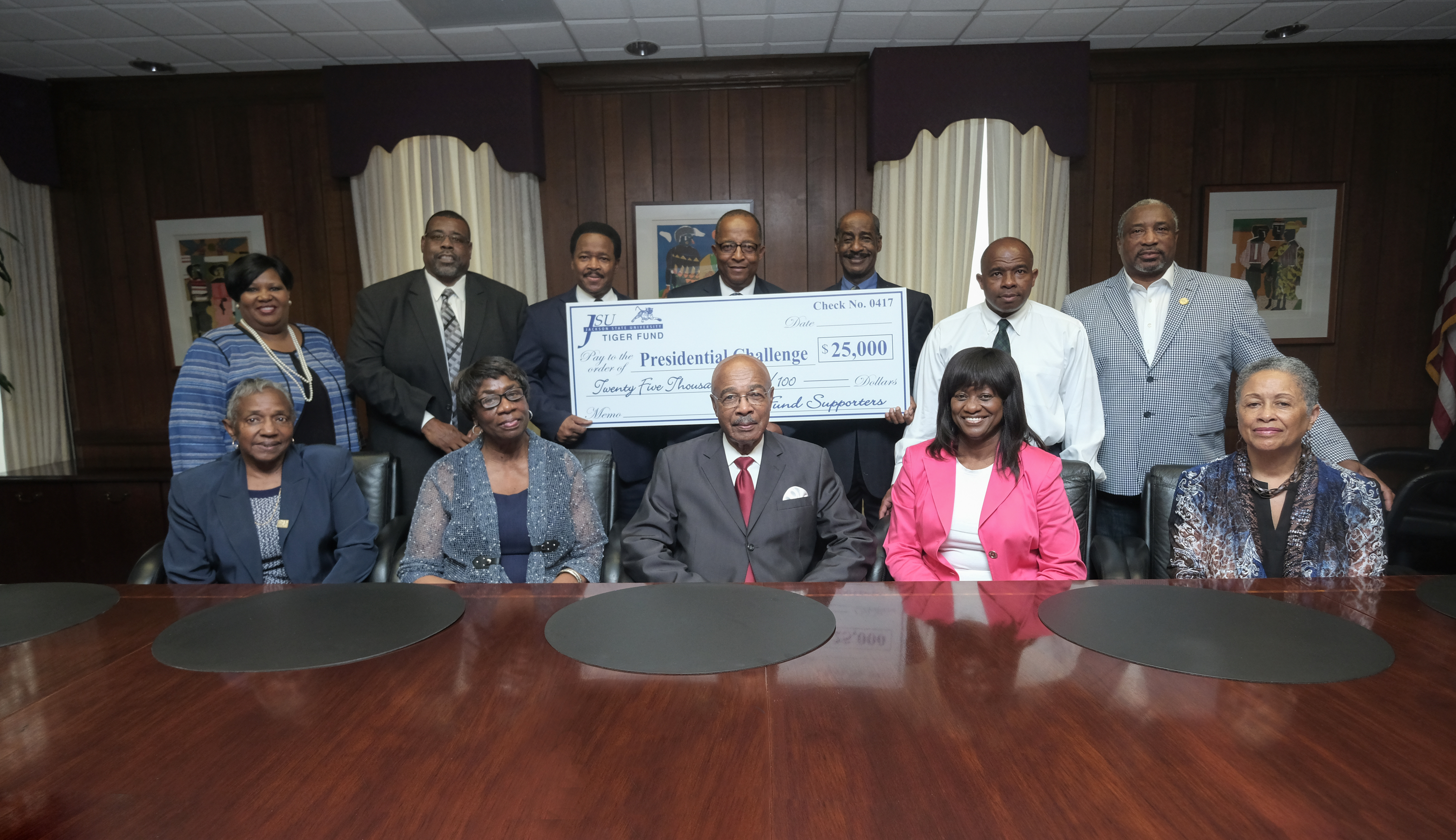 Present at the check presenation and seated Left to right: Maxine Johnson; Clemontine Whitaker; JSU Interim-President Dr. Rod Paige; Gloria Tatum; Gailya Porter Standing Left to right: Sandra Hodge, vice president of JSU institutional advancement; Wheeler Brown, director of JSU athletics; Lindsey Horton, associate vice president of JSU public safety; Robert Cook, president of the JSU Tiger Fund; Jesse Thompson; Eltorry Ficklin and Jimmie Harmon (Photo by Charles A. Smith/JSU)