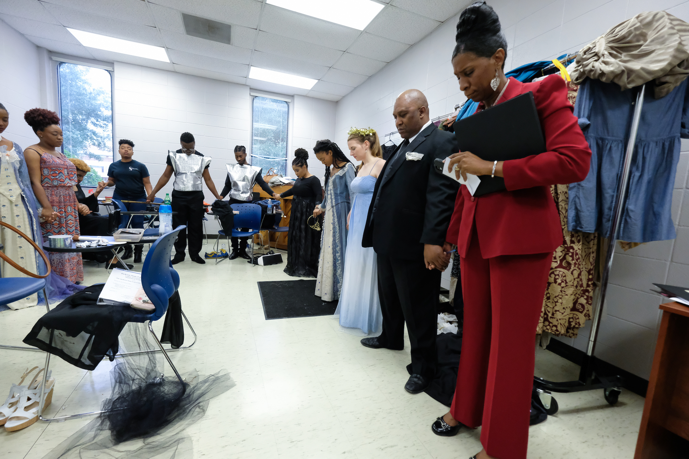 Dr. Phyllis Lewis Hale, director of the music opera musical theatre ensemble; Jerry Smith, piano accompanist and her students gather in a word of prayer before blazing the stage. (Charles A. Smith/JSU)